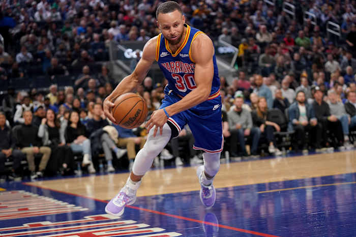 Mar 16, 2022; San Francisco, California, USA; Golden State Warriors guard Stephen Curry (30) saves the ball from going out of bounds against the Boston Celtics in the second quarter at the Chase Center. Mandatory Credit: Cary Edmondson-USA TODAY Sports